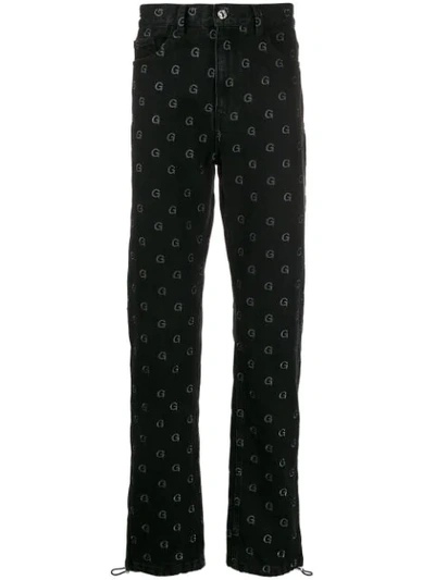 Shop Geo Monogram Print Trousers In Black