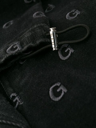 Shop Geo Monogram Print Trousers In Black