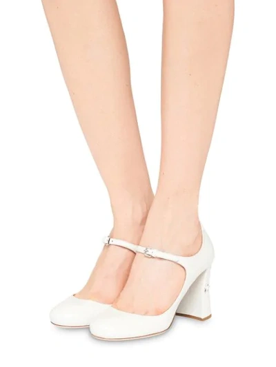 Shop Miu Miu Embellished Slanted Heel Pumps In White
