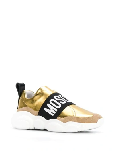 Shop Moschino Contrasting Panel Logo Sneakers In Gold