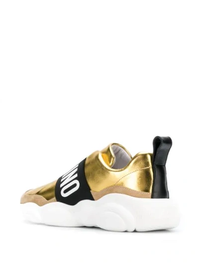 Shop Moschino Contrasting Panel Logo Sneakers In Gold