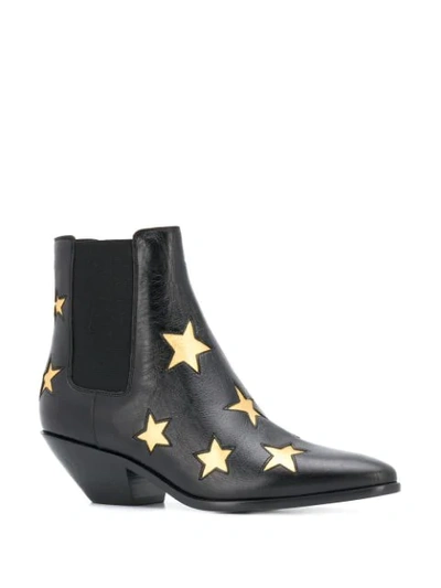 Shop Saint Laurent Star Embossed Ankle Boots In Black