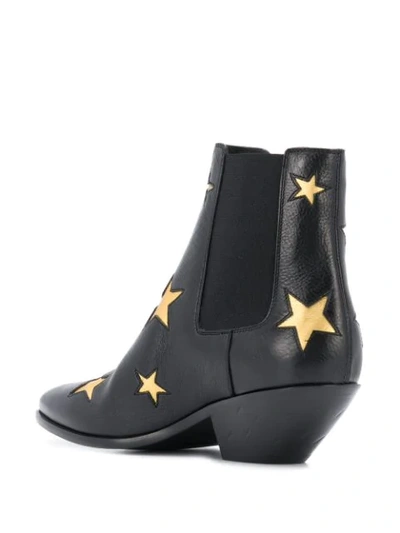 Shop Saint Laurent Star Embossed Ankle Boots In Black