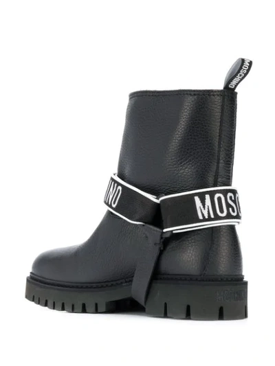 Shop Moschino Logo Strap Boots In 0000