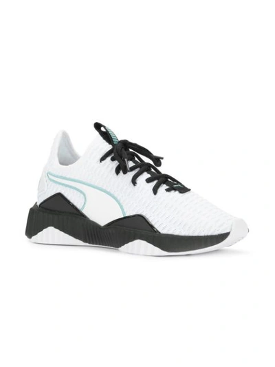 Shop Puma Defy Sneakers - White