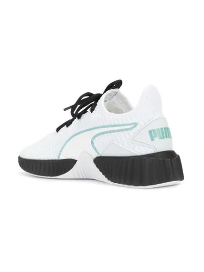 Shop Puma Defy Sneakers - White