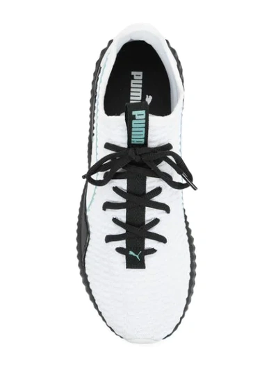 Shop Puma Defy Sneakers - White