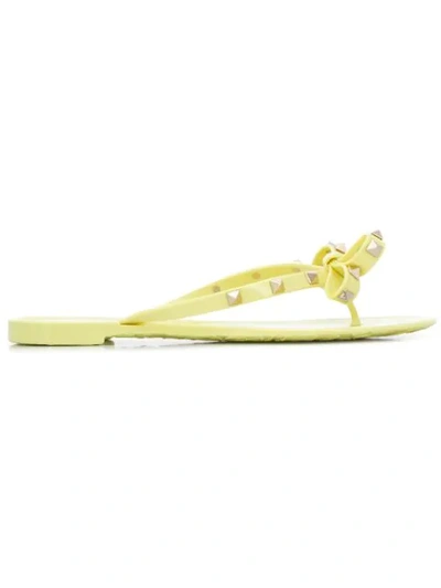 Shop Valentino Rockstud Bow Flip Flops In Yellow