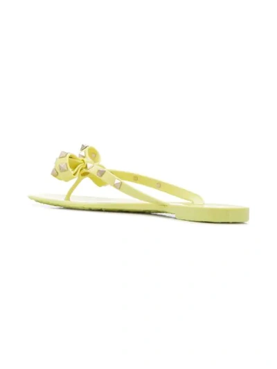 Shop Valentino Rockstud Bow Flip Flops In Yellow