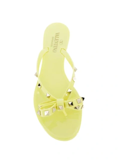 Shop Valentino Rockstud Bow Flip Flops In Yellow