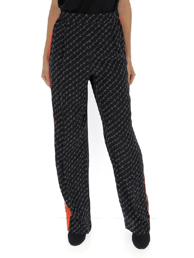 Shop Stella Mccartney All Over Logo Trousers In Black