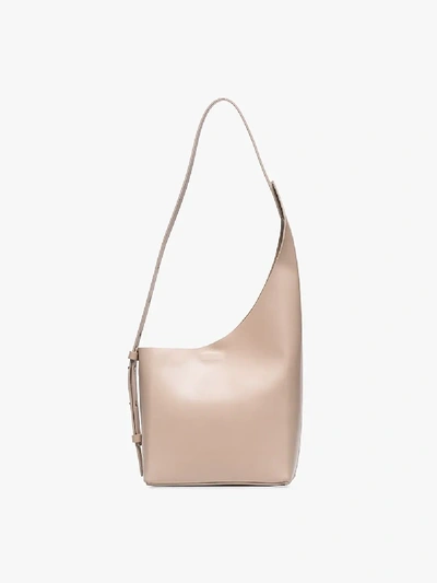 Shop Aesther Ekme Cream Demi Lune Asymmetric Bucket Bag In Neutrals