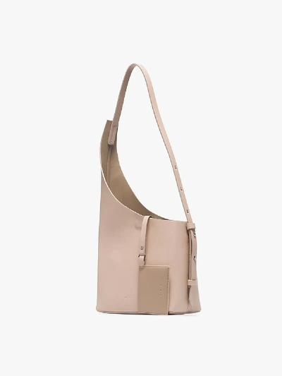 Shop Aesther Ekme Cream Demi Lune Asymmetric Bucket Bag In Neutrals