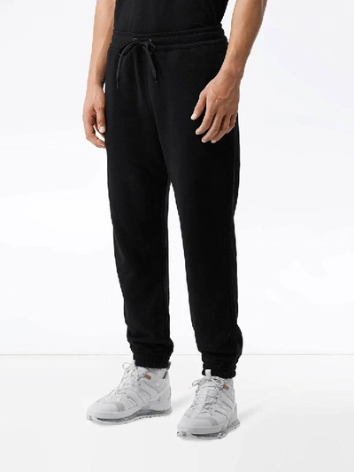 Shop Burberry Logo Appliqué Track Pants In Black