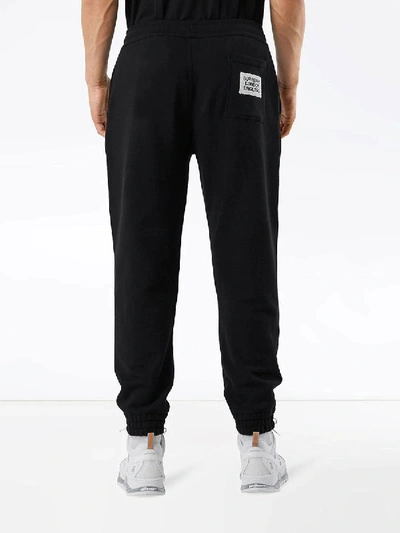 Shop Burberry Logo Appliqué Track Pants In Black