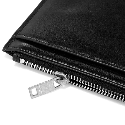 Shop Saint Laurent Ysl Metal Logo Zip Pouch In Black