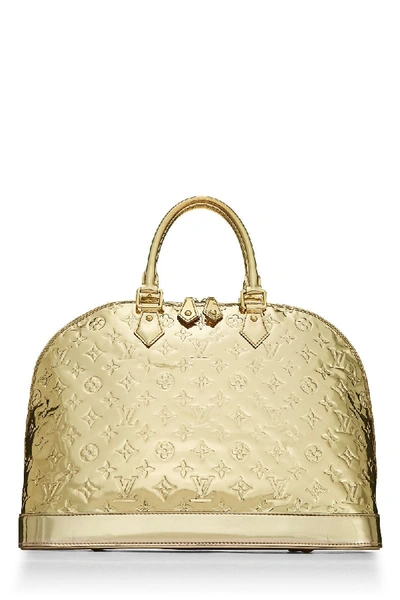 ✨NEW ARRIVAL✨ Louis Vuitton Gold Monogram Miroir Alma GM $3,800.00  Material: PVC Hardware: Gold-tone Colour: Gold Size: 15”L x 6”W x…