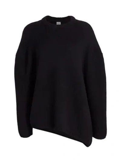 Shop Totême Noma Asymmetrical-hem Merino Wool Sweater In Black