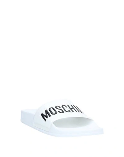 Shop Moschino Sandals In White