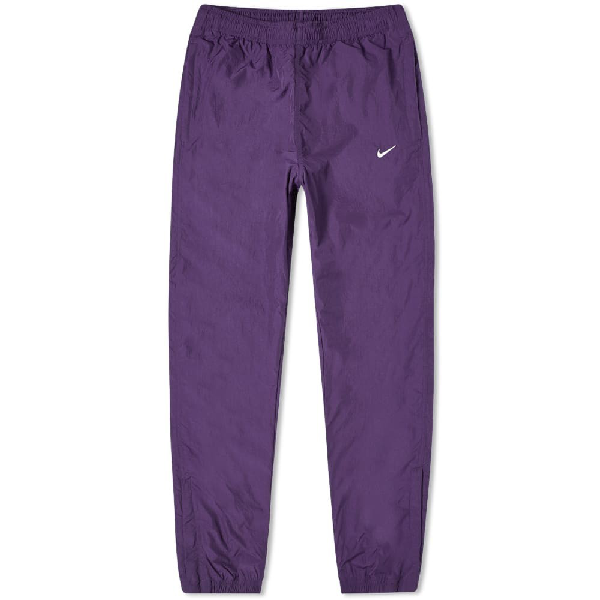 purple nike track pants