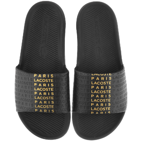 black and gold lacoste slides