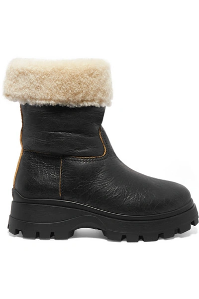 Shop Miu Miu Shearling-lined Cracked-leather Ankle Boots In Black