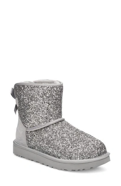 Shop Ugg Classic Cosmos Bow Mini Bootie In Silver Fabric