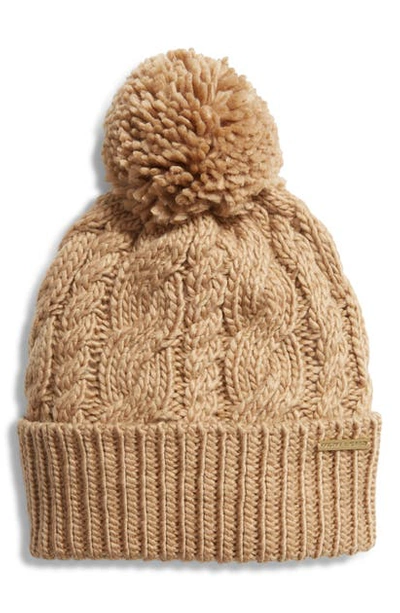 Shop Michael Michael Kors Pompom Cable Knit Beanie In Dark Camel