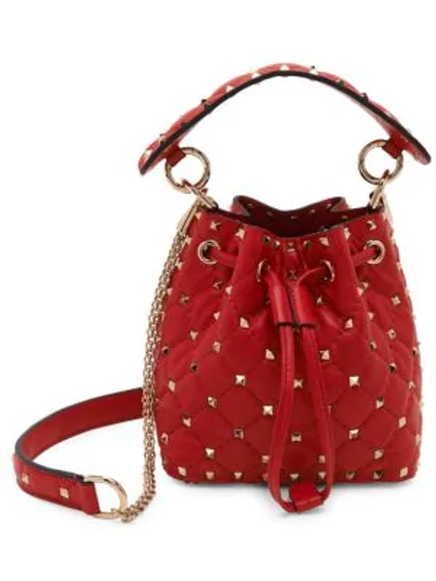 Shop Valentino Garavani Mini Rockstud Spike Leather Bucket Bag In Deep Red