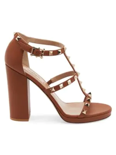 Shop Valentino Rockstud T-strap Leather Sandals In Camel