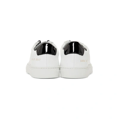 Shop Common Projects White And Black Retro Low Glossy Sneakers In 0547 Wht/bl