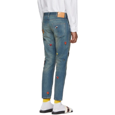 Tapered Denim Pant With Symbols In Blue