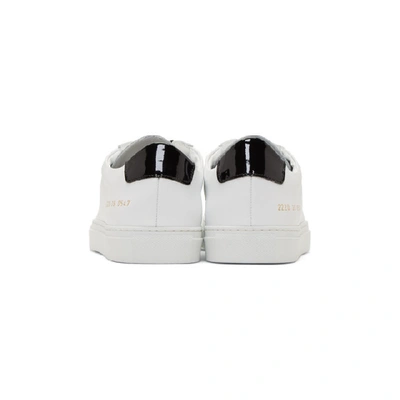 Shop Common Projects White And Black Retro Low Glossy Sneakers In 0547 Whtblk
