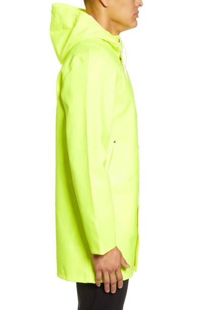 Shop Stutterheim Stockholm Waterproof Hooded Raincoat In Safety Yellow
