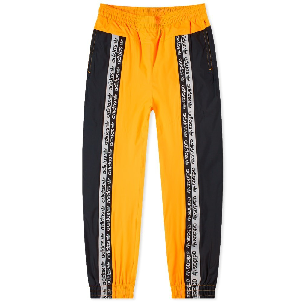 black and yellow adidas track pants