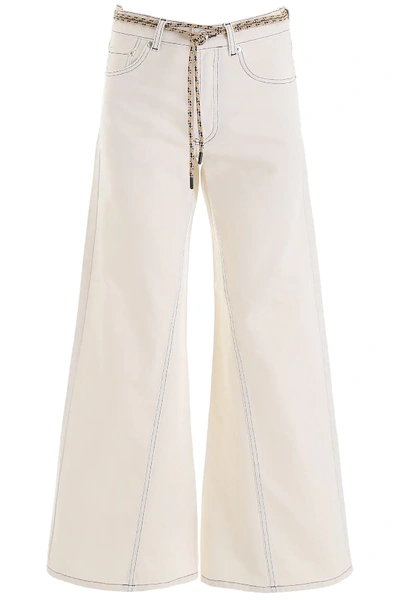 Shop Ganni Flared Jeans In White