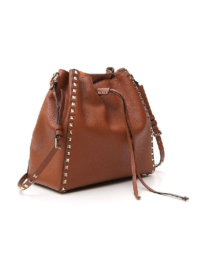 Shop Valentino Garavani Rockstud Studded Bucket Bag In Brown