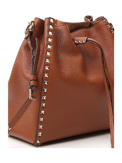 Shop Valentino Garavani Rockstud Studded Bucket Bag In Brown