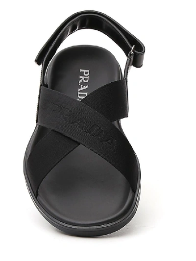 Shop Prada Cross Strap Logo Embossed Sandals In Black