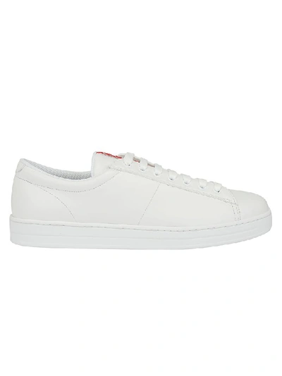 Shop Prada Logo Embossed Sneakers In White