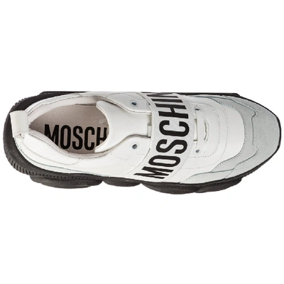 Shop Moschino Logo Strap Low Top Sneakers In White