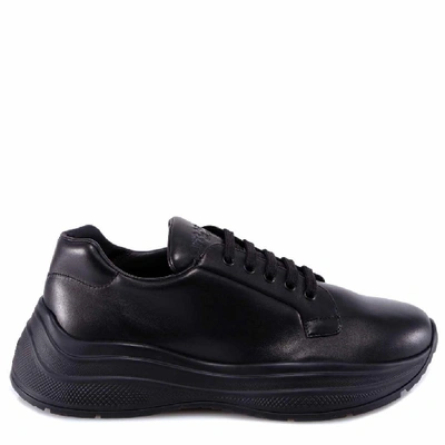 Shop Prada Logo Embossed Sneakers In Black