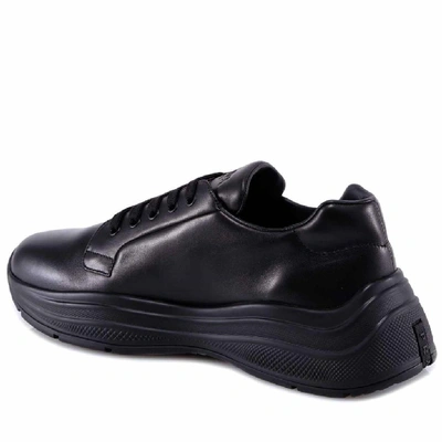 Shop Prada Logo Embossed Sneakers In Black