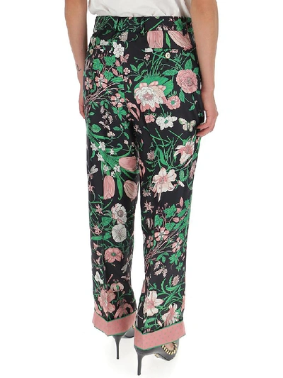 Shop Gucci Floral Printed Trousers In Multi