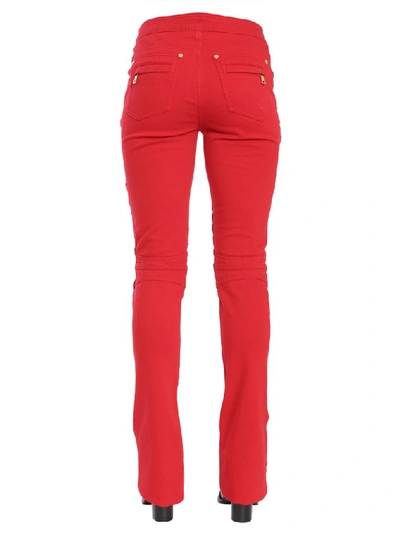 Shop Balmain Button Embellished Flare Jeans In Red