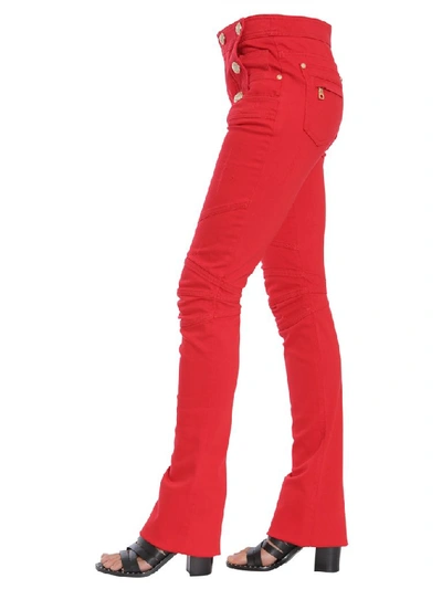 Shop Balmain Button Embellished Flare Jeans In Red