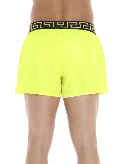 Shop Versace Greca Trimmed Swim Shorts In Yellow