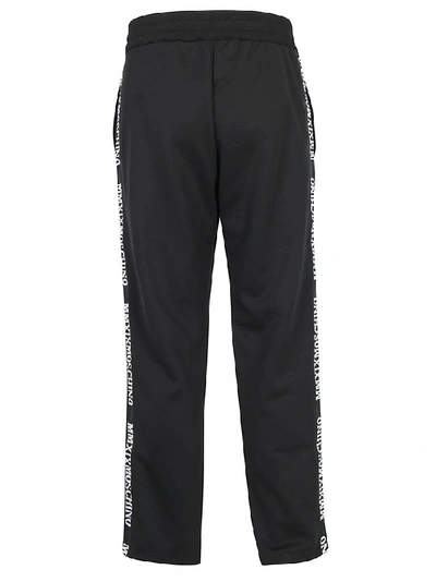 Shop Moschino Logo Band Track Trousers In Black
