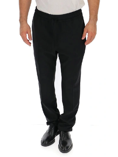 Shop Versace Elasticated Waist Trousers In Black