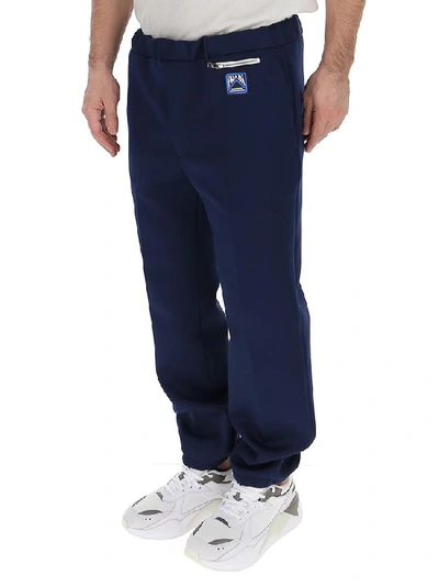 Shop Prada Logo Zip Pocket Trousers In Blue